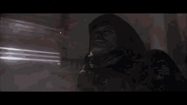 a person 's hand is visible in a dark room