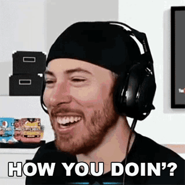 a man wearing headphones and a headband is laughing and asking how you doin ?