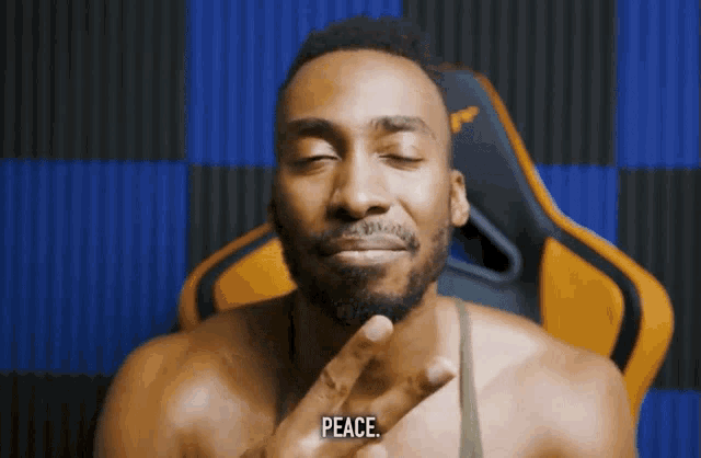 a man making a peace sign with his hand