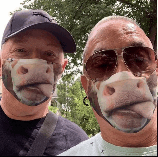 two men wearing face masks with a picture of a horse 's face on them