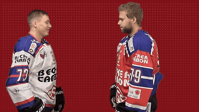 two hockey players shaking hands with one wearing the number 79 on his jersey