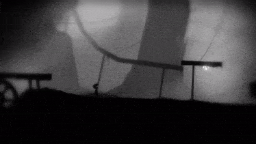 a black and white photo of a person standing in the fog