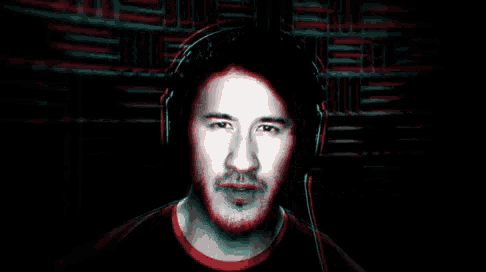 a man with headphones on looks at the camera
