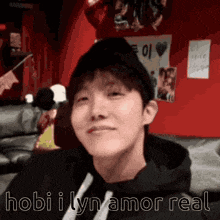 a close up of a person 's face with the words hobi i lyn amor real written on the bottom .