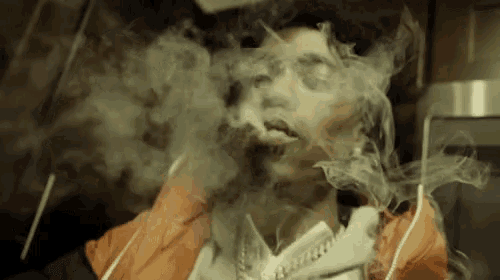 a man in an orange jacket is smoking a cigarette