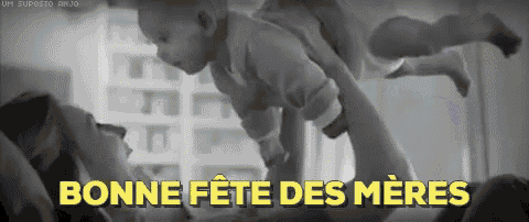 a black and white photo of a woman holding a baby with the words bonne fete des meres written in yellow