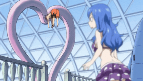 a girl with blue hair stands next to a heart shaped object