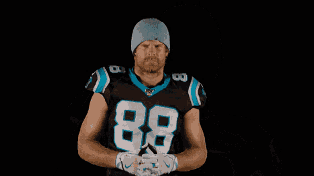 a man wearing a beanie and a jersey with the number 80