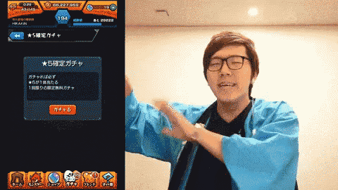 a man wearing glasses and a blue kimono stands in front of a screen that says ' 5 ' on it