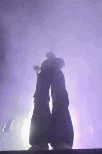 a person 's legs are visible in a purple light
