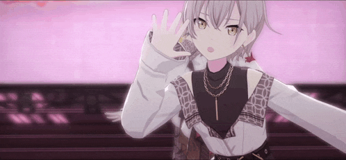 a girl with short hair and a necklace is standing on a stage .