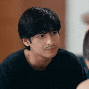 a young man has a blue line drawn on his face