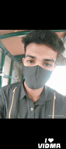a man wearing a black face mask with the words i love vidma on the bottom right