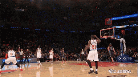 a basketball player wearing a number 51 jersey is jumping in the air