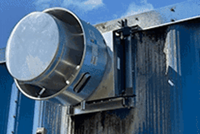 a metal object is mounted to a blue wall