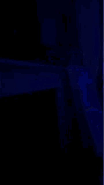 a blurry picture of a dark room with blue lights