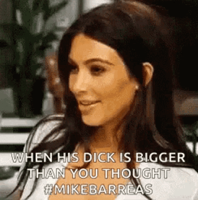 kim kardashian is smiling while talking to a man .