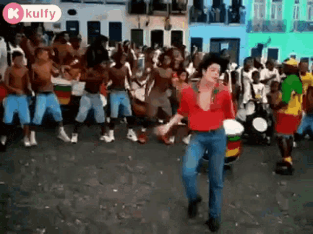 michael jackson is dancing in front of a crowd of people .