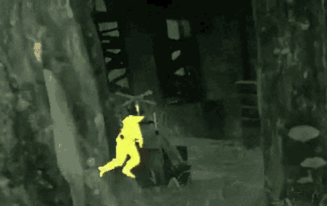 a yellow silhouette of a person standing in the dark