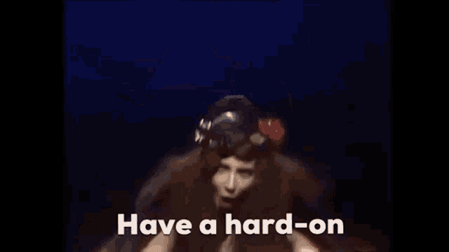 a woman with long hair and a helmet says have a hard-on .