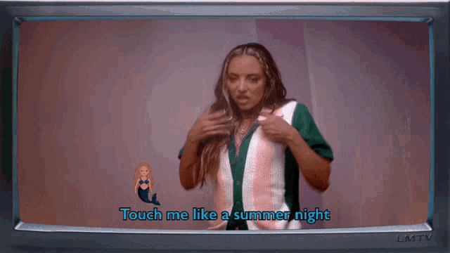 a woman is standing in front of a screen that says touch me like a summer night on it