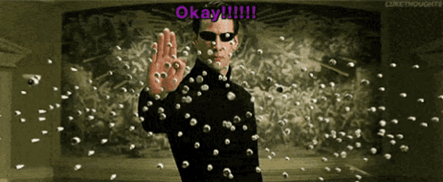 a man is surrounded by bullets and says " okay "