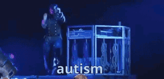 a man is standing in front of a machine with the word autism written on it