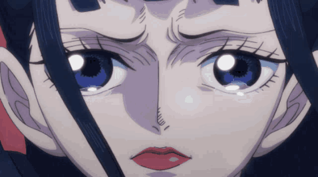 a close up of a person 's face with a tear coming out of her eye