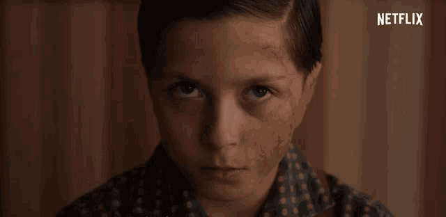 a close up of a young boy 's face with a netflix logo in the corner