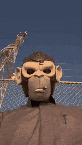 a man wearing a monkey mask with the letter n on his forehead