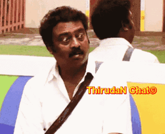 a man with a sling around his shoulder is talking to another man with the words thiruda n chat on the bottom