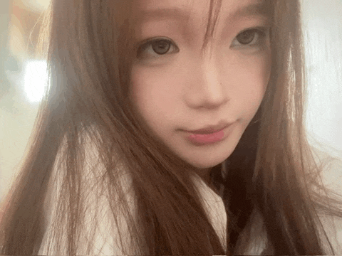 a close up of a girl 's face with long hair
