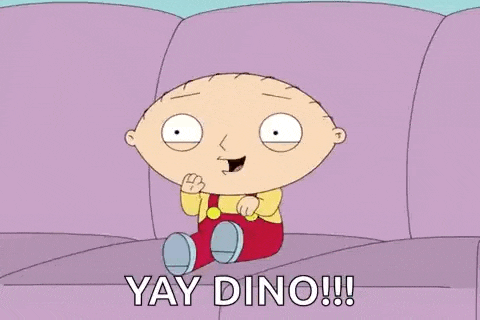 stewie from family guy is sitting on a purple couch and saying yay dino .