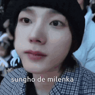 a close up of a person 's face with the words sungho de milenka written on it .
