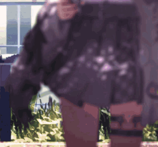 a blurry picture of a person in a purple skirt