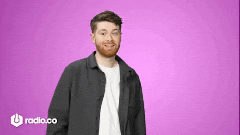 a man with a beard is standing in front of a purple background with radio.co written on the bottom right