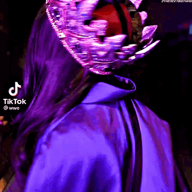 a woman wearing a purple cape and a crown with a tiktok logo behind her