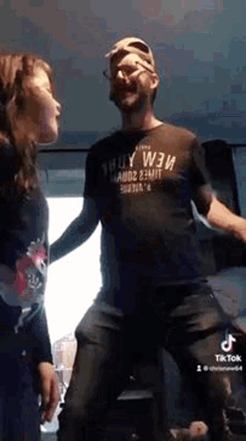 a man and a woman are dancing together in a room .