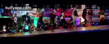 a group of people are dancing on a stage and the website kulfyapp.com is visible in the corner