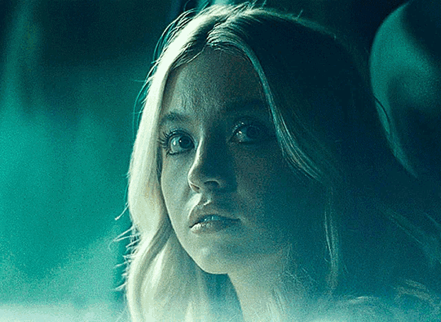 a close up of a woman 's face in the dark