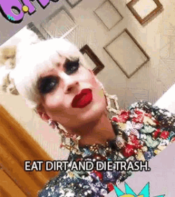 a drag queen is taking a selfie and says `` eat dirt and die trash . ''