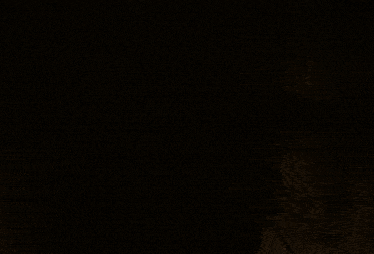 a person with a fur hood is standing in a dark room