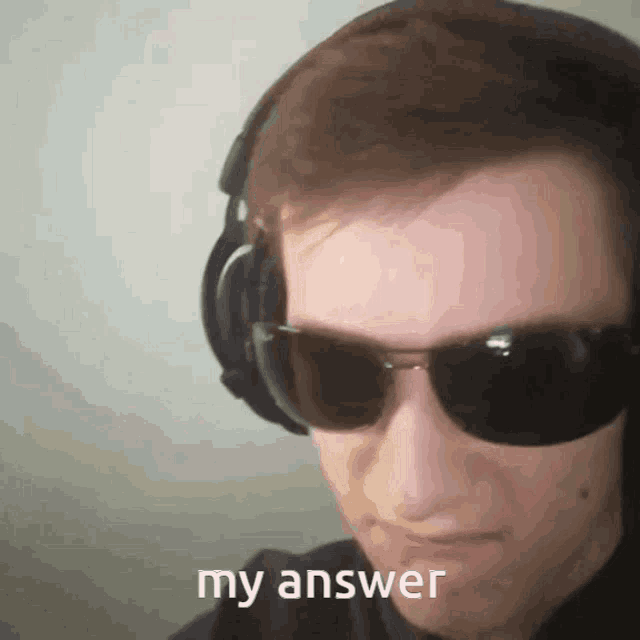 a man wearing headphones and sunglasses has the word my answer on his face