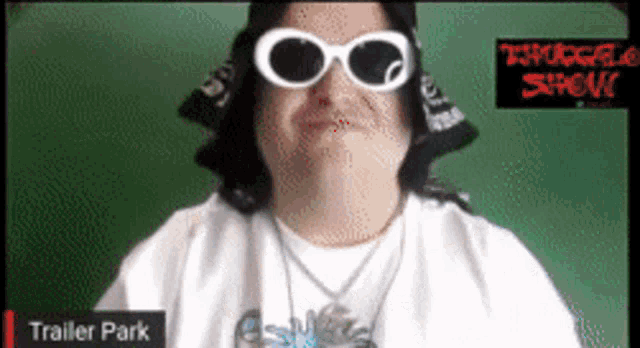 a man wearing sunglasses and a hat with the words trailer park on the bottom