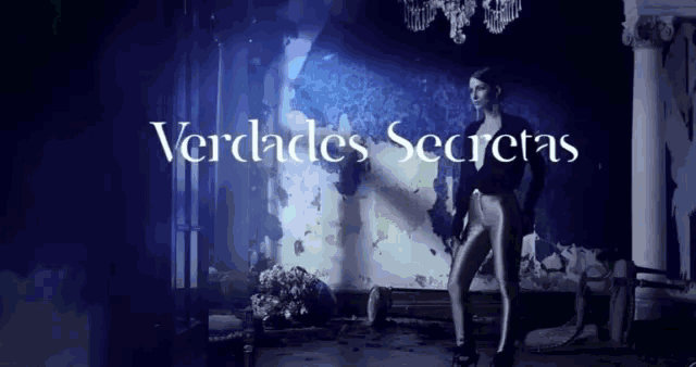 a woman stands in front of a wall with the words verdades secretas