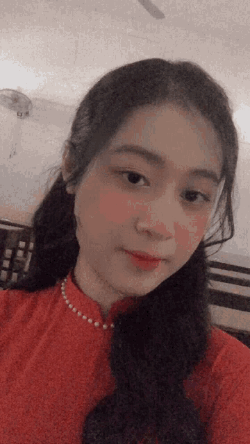 a woman in a red dress takes a selfie