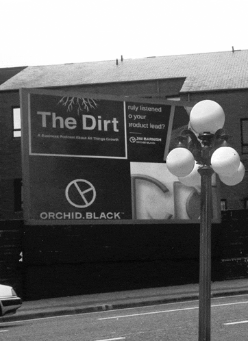 a black and white photo of a billboard that says the dirt