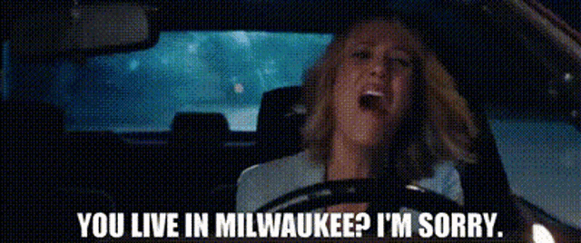 a woman is driving a car at night and says you live in milwaukee ? i 'm sorry .
