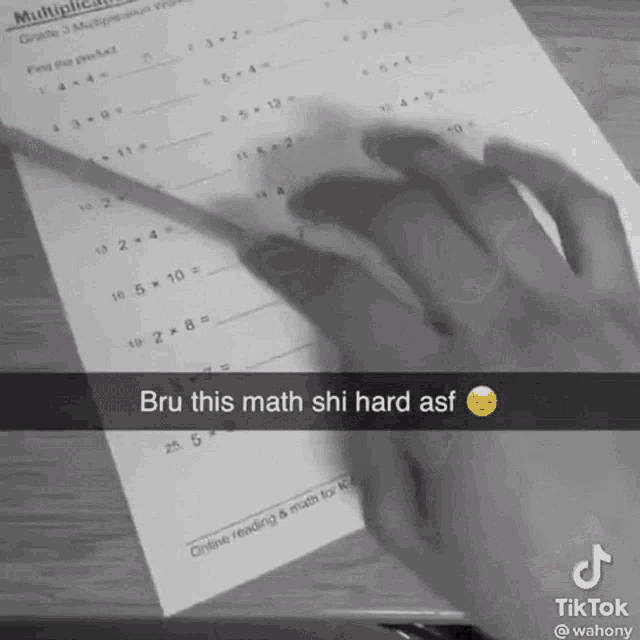 a black and white photo of a person doing a math worksheet