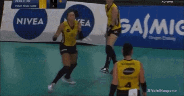 a group of female volleyball players wearing dentil jerseys